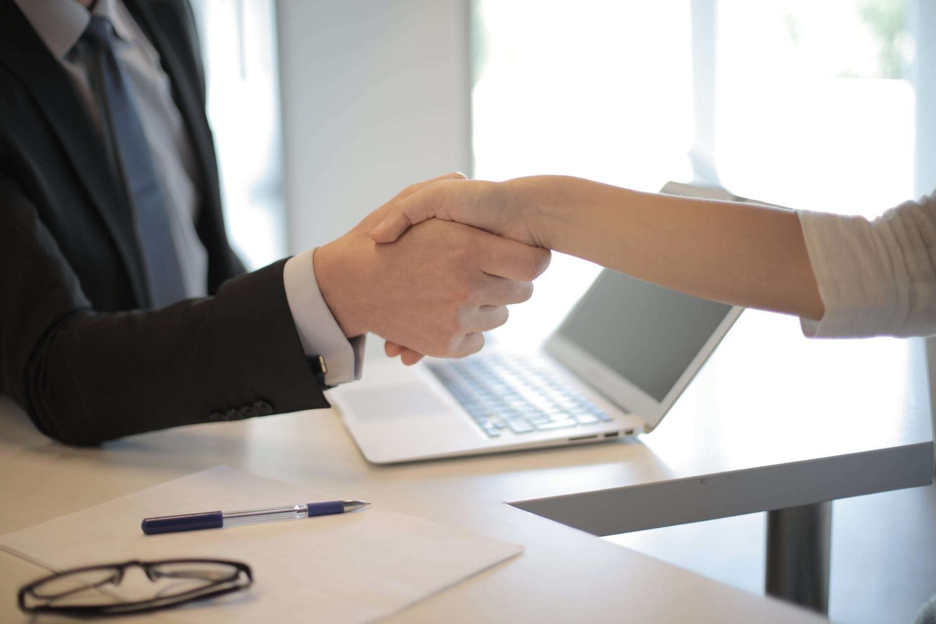 an image of two people shaking hands in agreement