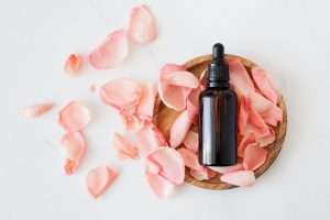 natural oil's bottle on rose petals
